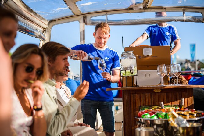Amsterdam: Canal Booze Cruise with Unlimited Drinks Option - Passing Through the Red Light District: What You Need to Know