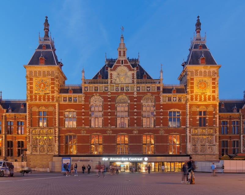 Amsterdam: City Highlights Walking Tour - Damrak Shopping Views and the Names You Will Recognize Later