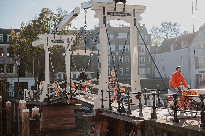 Amsterdam City Top Highlights Guided Bike Tour - Leidseplein and Dam Square: classic centers with short photo windows