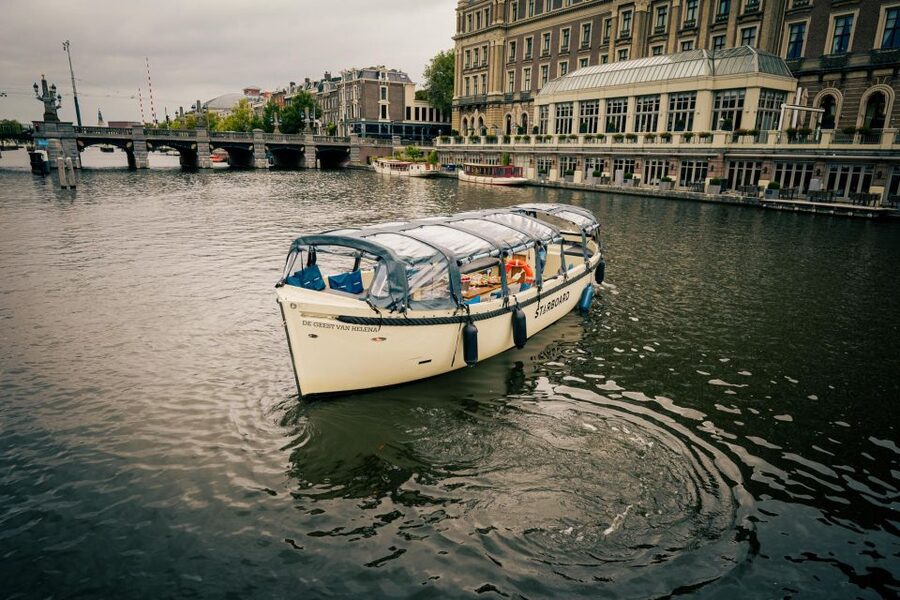 Amsterdam: Covered Canal Booze Cruise with Unlimited Drinks - The boat setup on Starboard Boats, covered comfort and a small crowd