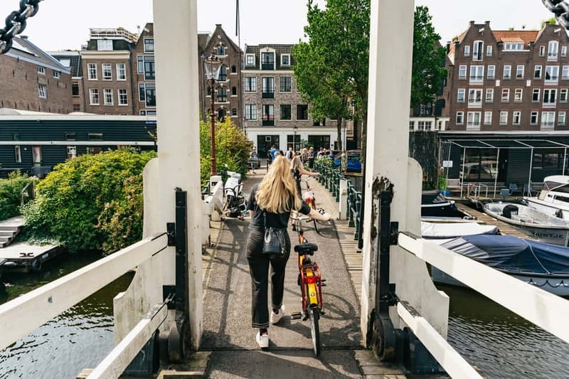 Amsterdam: Guided Bike Tour City Centre in EN/DE/FR/ES - Western Islands and Canal Views: Drawbridges, Warehouses, and Brouwersgracht
