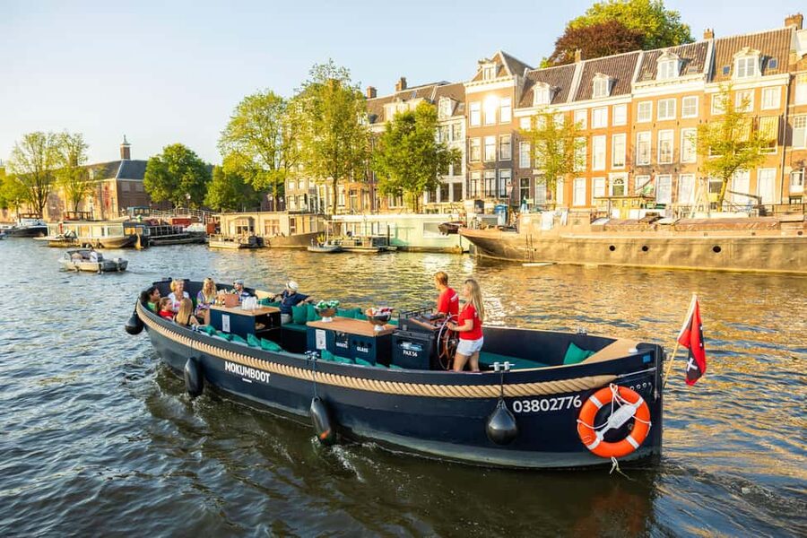 Amsterdam: Guided Open Boat Canal Cruise Including Drink - The guide and the vibe: light, local, and actually informative
