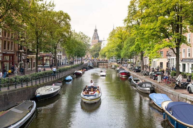 Amsterdam: Open Boat Tour of Canals with Expert Local Guide - Why this open-boat format makes Amsterdam feel real fast