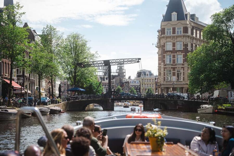 Amsterdam: Open Boat Tour of Canals with Expert Local Guide - Comfort and practical tips for open-air cruising
