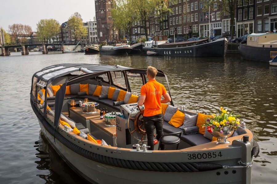 Amsterdam: Private BBQ Cruise with Personal Chef & Drinks - Entering Amsterdam by boat, with BBQ as the main event