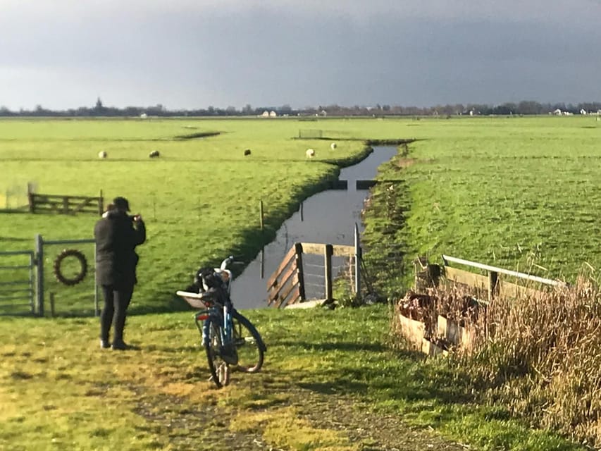 Amsterdam: Rainbow Rural Bike Tour With Local Gay Guide - The abandoned harbor and the mural-filled artist side of Amsterdam