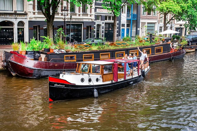 Amsterdam Small-Group Canal Cruise With Dutch Snacks and Drink - Old Amsterdam corners, flea market energy, and an LGBTQ+ monument