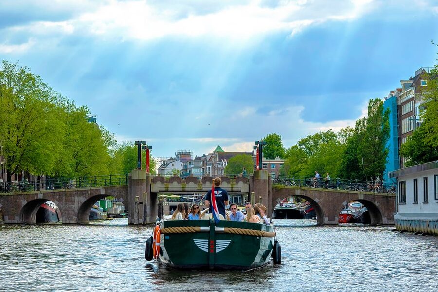 Amsterdam: The Newest Canal Cruise with Drink Option - Skipper storytelling, digital guide, and the no-microphone rule