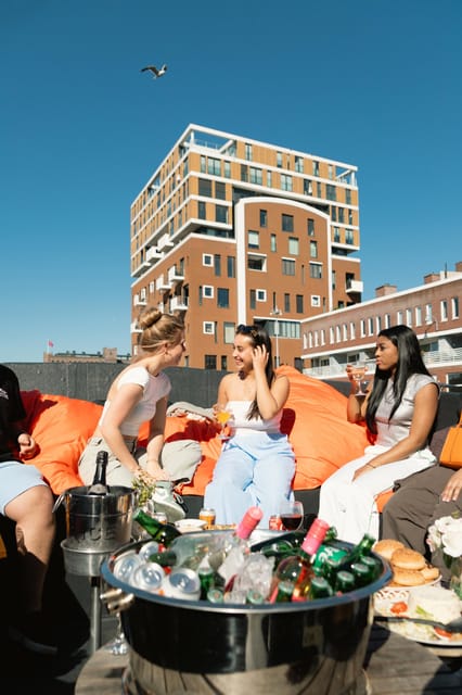 Haarlem Private Canal Tour with Bites and Unlimited Drinks - Boarding on a cozy sloop, drinks in hand