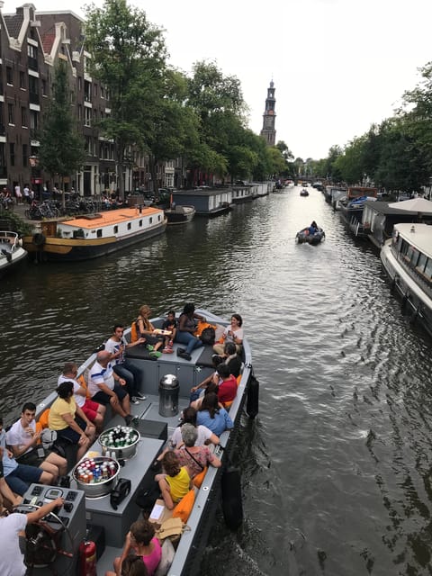Visit Amsterdam by Boat with a French Guide (french) - Small Electric Boat, Quiet Canals, and a Much Better Sense of Space